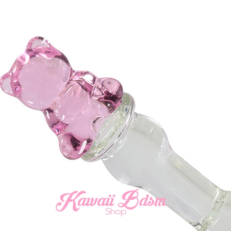 Close-up angled view of the cute pink glass teddy bear handle on the petite BDSM pleasure wand.