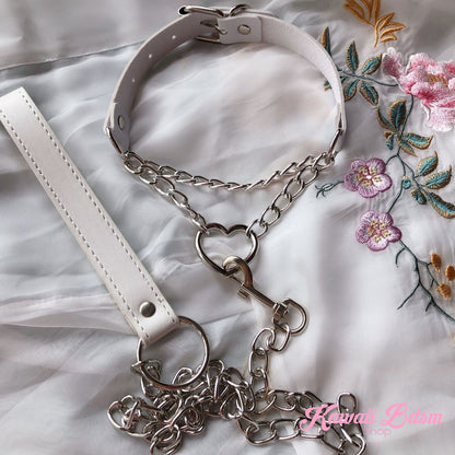 Flatlay display of the white leather bondage collar combo with its matching white leather leash and silver hardware on a soft surface.