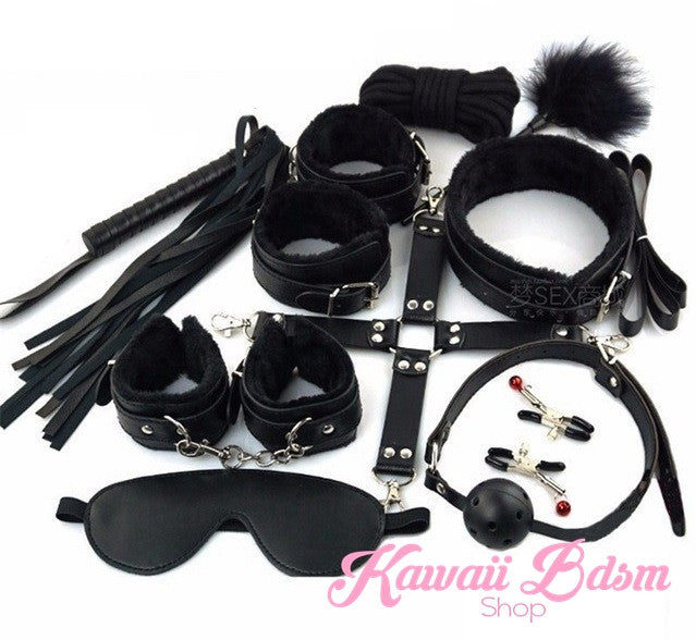 Complete 10-piece black bondage set featuring vegan leather cuffs, ball gag, flogger, and nipple clamps.