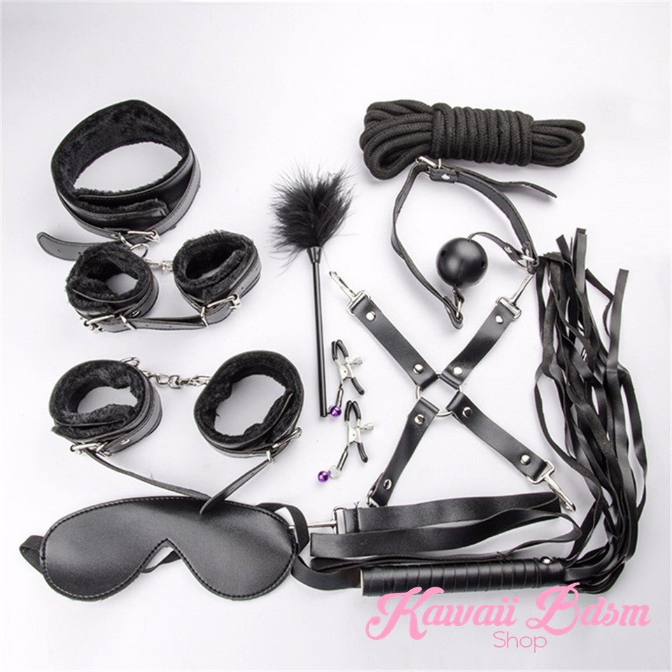 Close-up of the black flogger, feather tickler, and adjustable nipple clamps included in the 10-piece set.