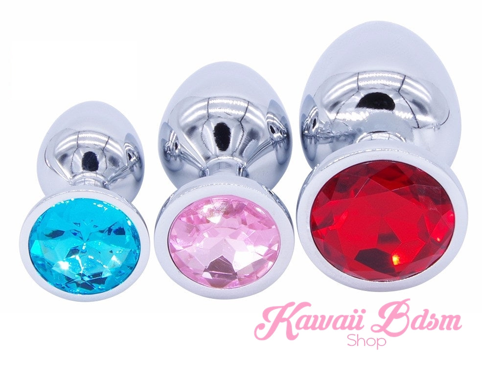 Three classic jewel stainless steel plugs featuring bright blue, pastel pink, and ruby red crystal bases standing upright.