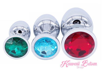 A colorful and bright mixed 3-piece metal training plug set featuring emerald green, light blue, and ruby red sparkling jewel bases.