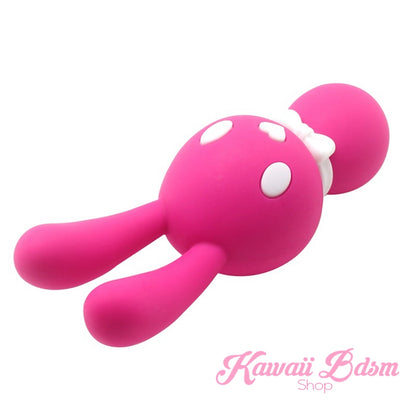 A hot pink Mitzi bunny wand vibrator leaning to the side, highlighting its smooth, playful, and ergonomic design