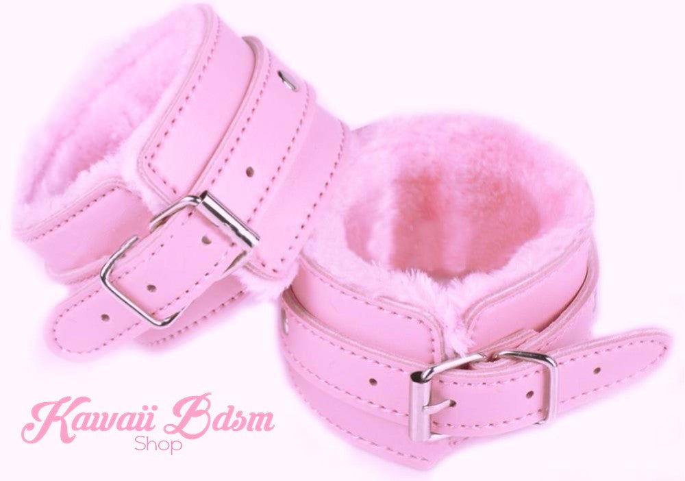 A beautiful pair of pastel pink vegan leather cuffs with soft matching faux fur lining and silver buckle closures.