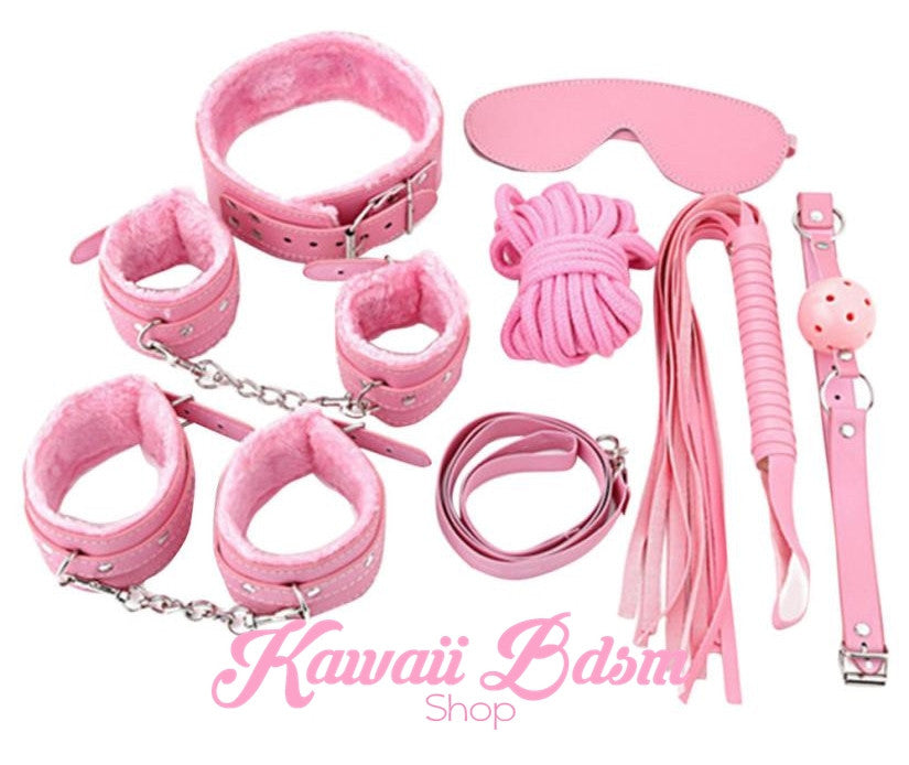 Complete 7-piece pink bondage starter kit featuring faux fur cuffs, collar, leash, rope, whip, and blindfold.