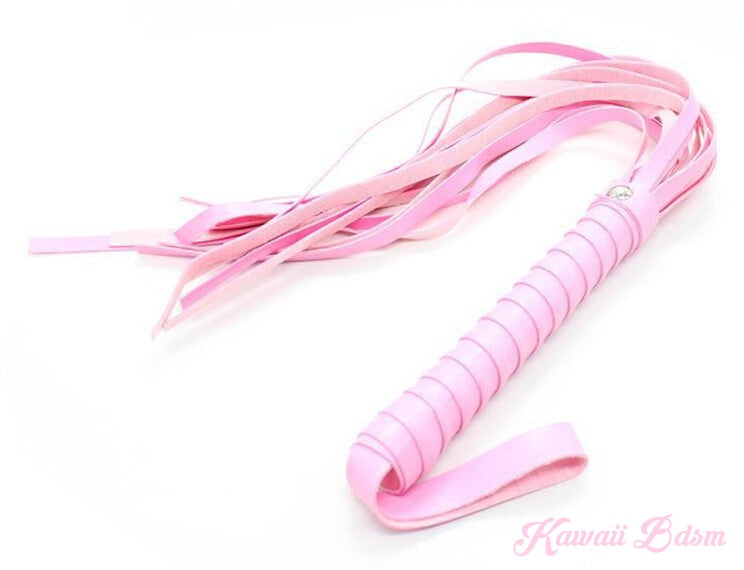 Close-up of the pink bondage whip with a braided handle, part of the 7-piece kinky set.