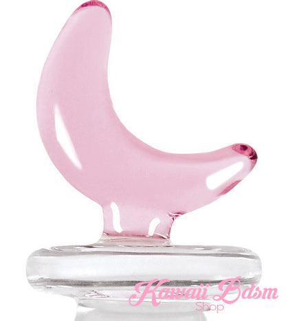 Close-up detail of the pastel pink glass crescent moon handle of the pleasure wand.