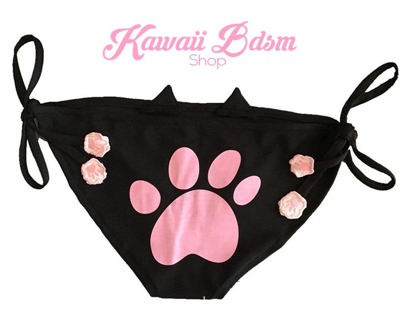 Flat lay back product view of the black neko cosplay panties, highlighting the adorable pink kitten paw print design stamped perfectly on the cheeky booty and the black adjustable side tie strings.