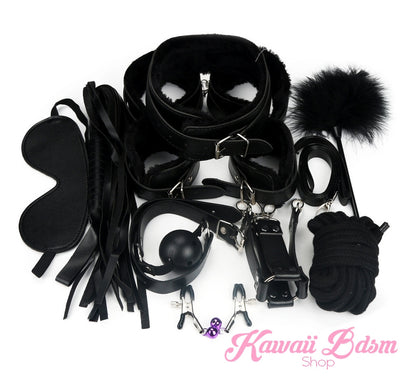 Detailed view of the black bondage cuffs and collar with soft vegan plush lining for comfortable play.