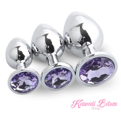 Three beautifully weighted stainless steel training plugs featuring vibrant purple diamond-cut faux crystal bases.