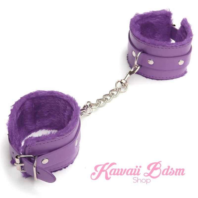 A pair of deep purple adjustable restraint cuffs featuring a soft fuzzy interior and heavy-duty metal hardware.
